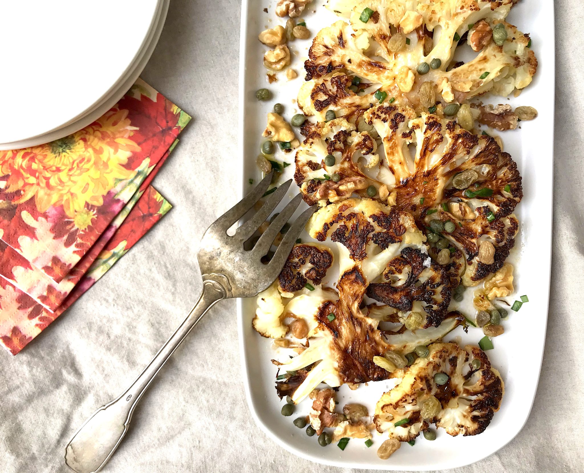 roasted cauliflower with caper vinaigrette, walnuts, and golden raisins